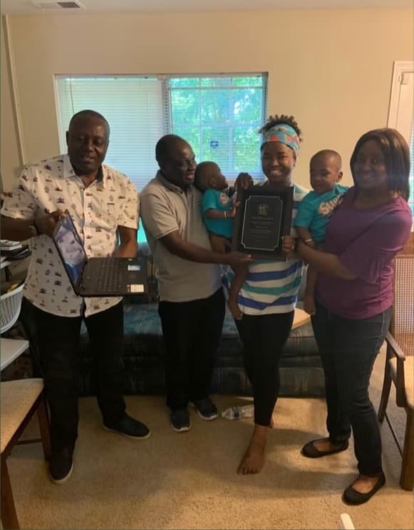 Family members presenting the Lifetime Achievement Award plaque on Father's Day 2019