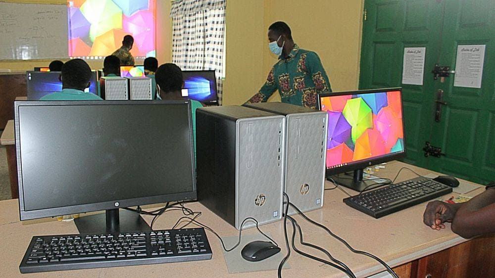 Close-up of HP Slimline tower and monitor on a student workstation in the ICT lab